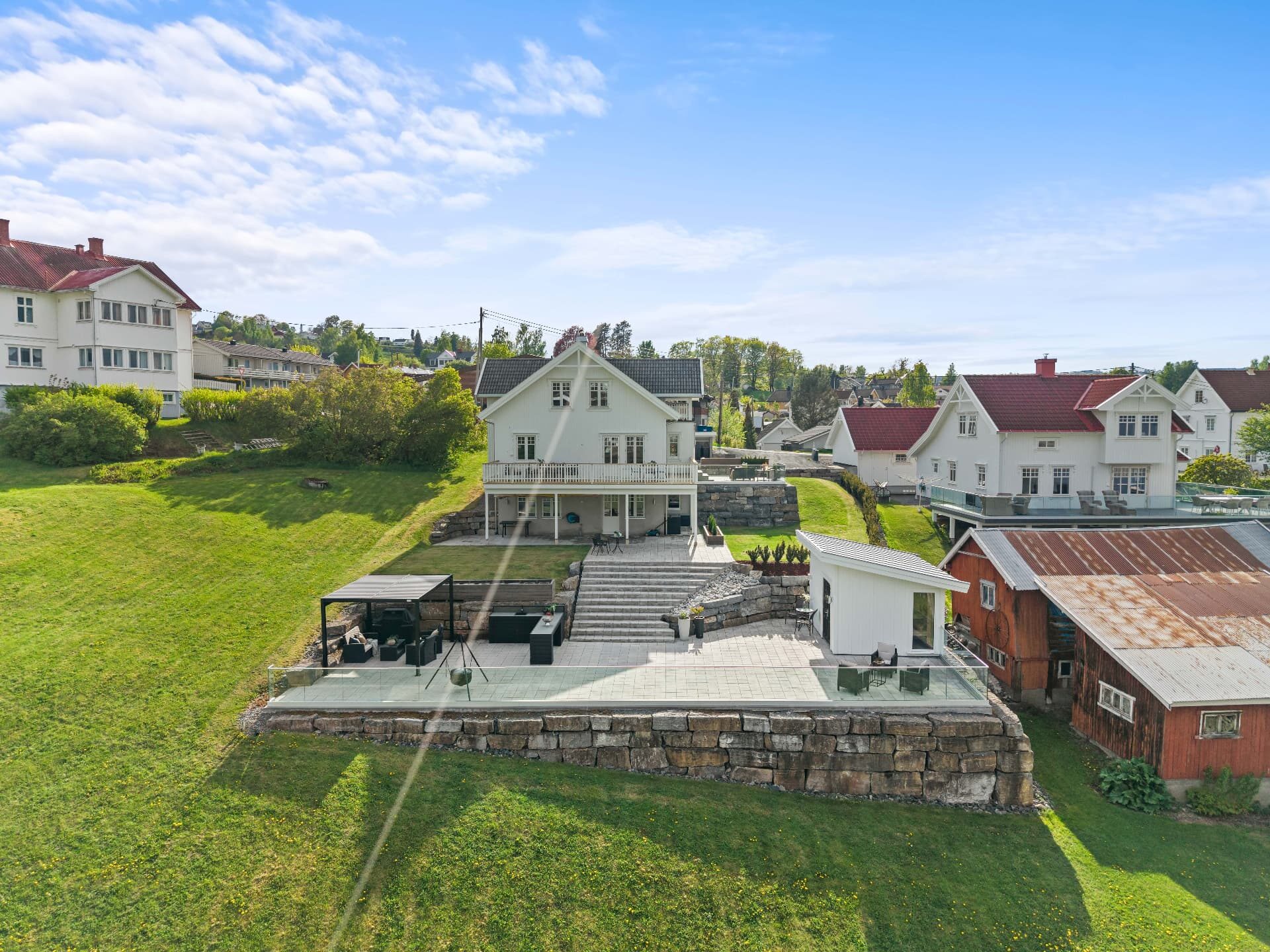Luftfoto av enebolig med steinmur og terrasse